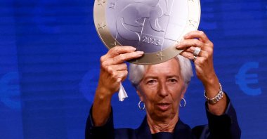 President of European Central Bank Christine Lagarde poses with a model of a euro coin after a signing ceremony on the adoption of the euro by Croatia in Brussels, Belgium, July 12, 2022. (Reuters Photo)
