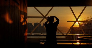 A shop worker tapes up a glass window in preparation for Typhoon Ragasa at a store in Hong Kong, China, Sept. 22, 2025. (Reuters Photo)