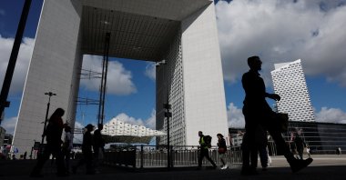 People walk past the Grande Arche at the financial and business district of La Defense, Paris, France, Sept. 12, 2025. (Reuters Photo)