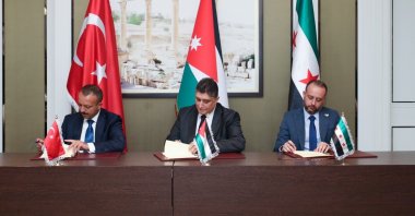 Turkish, Syrian and Jordanian officials sign an agreement in Amman, Jordan, in this undated photo. (IHA Photo)