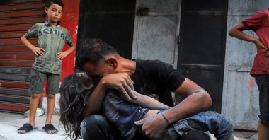 Palestinian father Dawoud Sukar embraces the body of his son Saker, 3, who was killed in Israeli strikes on houses at Shati (Beach) refugee camp, in Gaza City, Gaza Stip, Palestine, Sept. 23, 2025. (Retuers Photo)