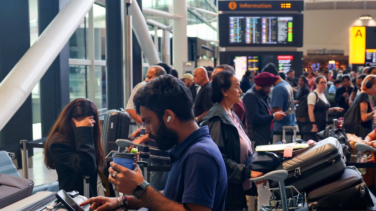 Travellers wait near check-in desks at Heathrow Airport Terminal 2, amid flight delays and cancellations, resulting from a disruption to check-in and boarding systems caused by a cyberattack which has affected several major European airports, London, Britain, Sept. 20, 2025. (Reuters Photo)