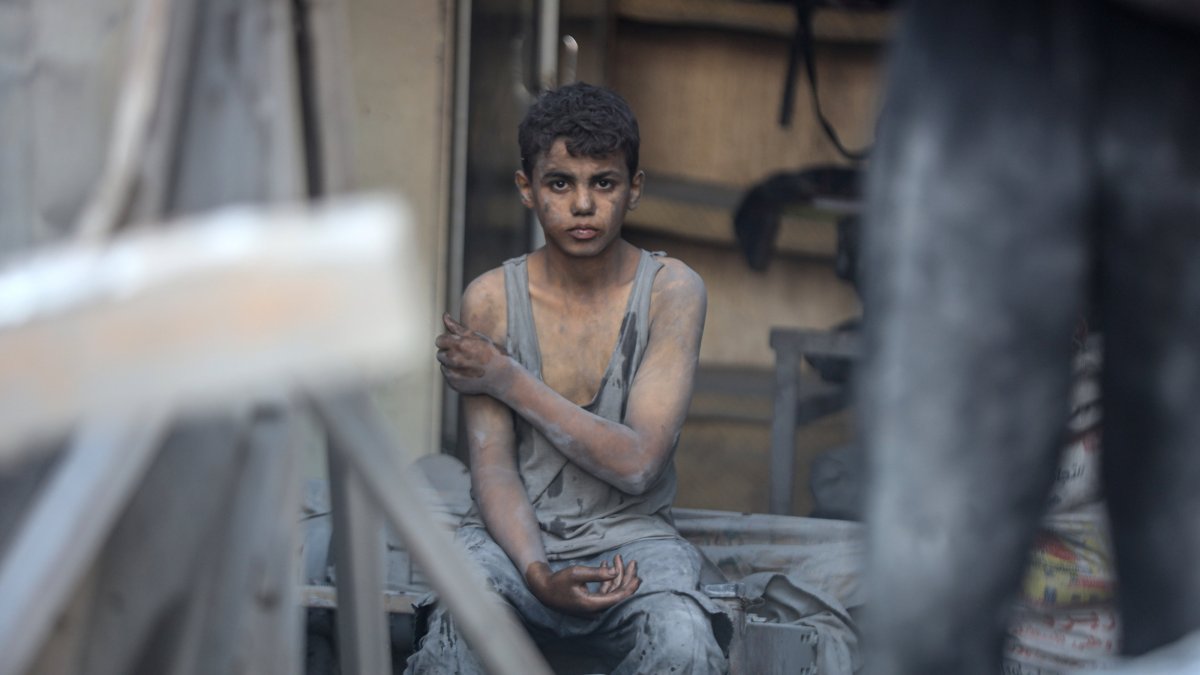 A Palestinian youth sits amid the rubble from a building destroyed in an Israeli attack, central Gaza, Palestine, Sept. 25, 2025. (AA Photo)