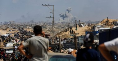Smoke rises from an Israeli strike, as displaced Palestinians, fleeing northern Gaza due to an Israeli military operation, move southward after Israeli forces ordered residents of Gaza City to evacuate to the south, in the central Gaza Strip, Palestine, Sept. 24, 2025. (Reuters Photo)