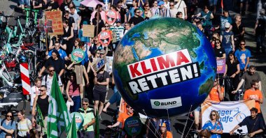 Participants walk with a giant inflatable Earth ball reading &#039;Save the climate&#039; during a Fridays for Future (FFF) climate strike rally in Berlin, Germany, Sept. 20, 2025. (EPA Photo)
