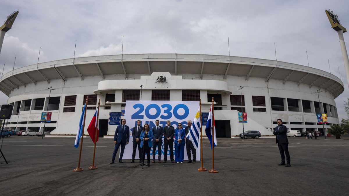 Government sports officials pose for photos outside the National Stadium after the opening ceremony for the creation of &quot;Corporation Juntos 2030,&quot; Santiago, Chile, Nov. 11, 2022. (AP Photo)