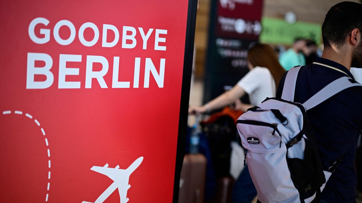 The lettering &quot;Goodbye Berlin&quot; is seen on a board as a passenger carrying a backpack walks at Terminal 1 of Berlin Airport, Germany, Sept. 20, 2025. (AFP Photo)