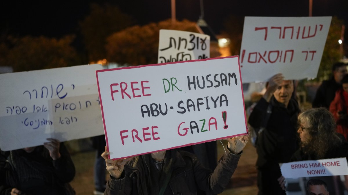A woman holds a sign that reads "Free Dr. Hussam Abu Safiya, Free Gaza" during a protest in front of the Shin Bet offices, calling for his release, in Tel Aviv, Israel, Wednesday, Jan. 1, 2025. (AP File Photo)