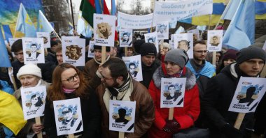 Ukrainian and Crimean Tatar activists hold portraits with the names of victims of the Russian annexation of Crimea during a rally, Kyiv, Ukraine, Feb. 26, 2017. (AP Photo)