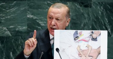 President Recep Tayyip Erdoğan shows a picture of a malnourished Palestinian infant from Gaza as he addresses the 80th United Nations General Assembly at U.N. headquarters, New York, U.S., Sept. 23, 2025. (Reuters Photo)