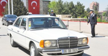 Nationalist Movement Party (MHP) leader Devlet Bahçeli drives his vintage Mercedes car, Ankara, Türkiye, April 23, 2013. (AA Photo)