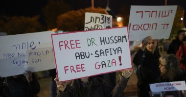A woman holds a sign that reads "Free Dr. Hussam Abu Safiya, Free Gaza" during a protest in front of the Shin Bet offices, calling for his release, in Tel Aviv, Israel, Wednesday, Jan. 1, 2025. (AP File Photo)
