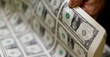 United States one-dollar bills are curled and inspected during production at the Bureau of Engraving and Printing in Washington, U.S., Nov. 14, 2014. (Reuters File Photo)