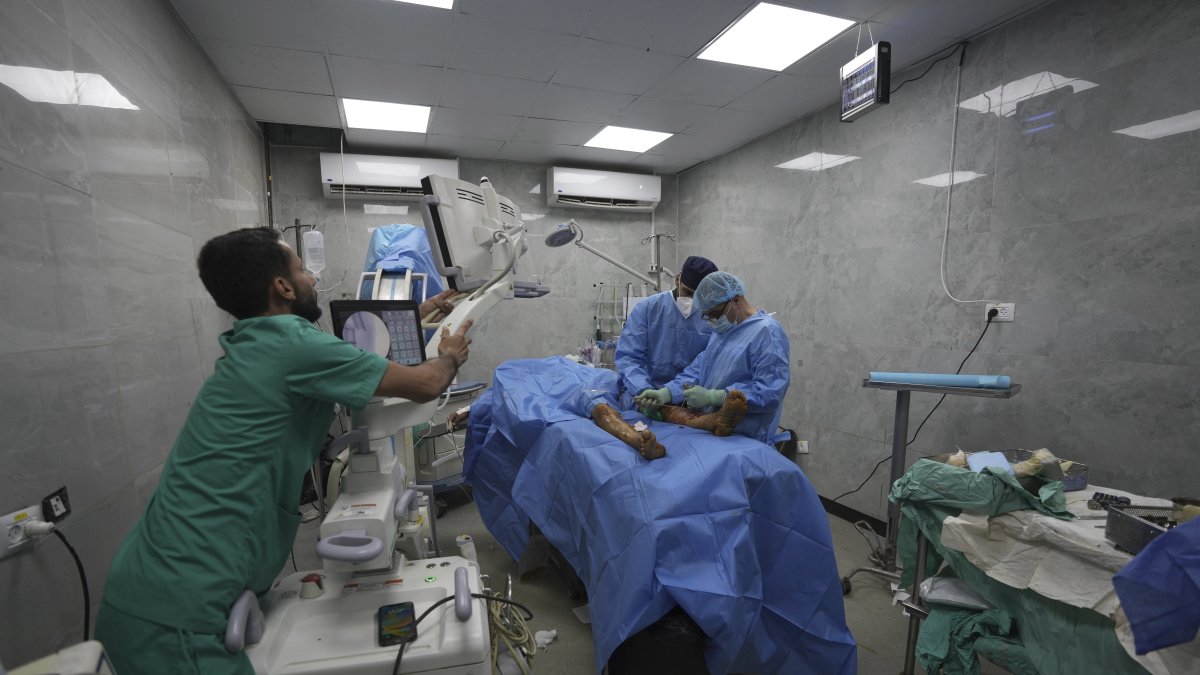 A medical team performs surgery on a patient with a foot injury caused by an Israeli strike, in an operating room with unstable electricity at Shifa Hospital, Gaza City, Palestine, July 4, 2025. (AP Photo)