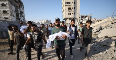 Mourners carry the bodies of Palestinians killed in Israeli strikes during their funeral at Al-Shifa Hospital in Gaza City, Sept. 27, 2025. (AAPhoto)
