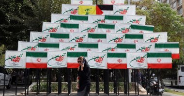 A woman walks past Iran&#039;s national flags in Tehran, Iran, Sept. 27, 2025. (EPA Photo)