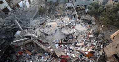 Palestinians check the rubble of a building destroyed by an Israeli strike in the Nuseirat refugee camp, Gaza Strip, Palestine, Sept. 28, 2025. (AFP Photo)