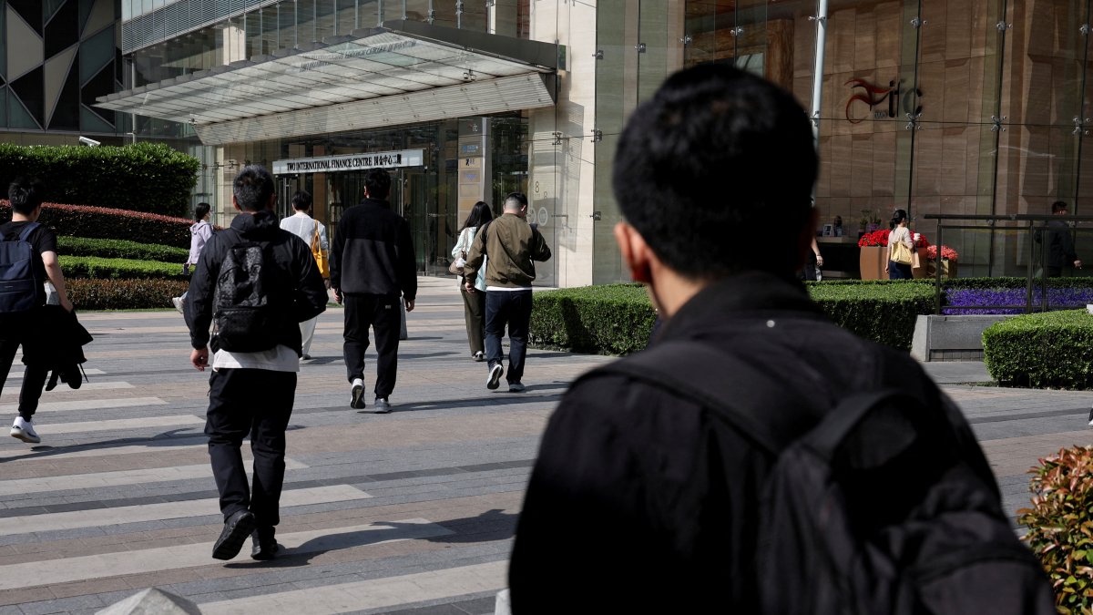 Commuters walk after exiting a metro station at the Lujiazui financial district in Shanghai, China, April 8, 2025. (Reuters Photo)