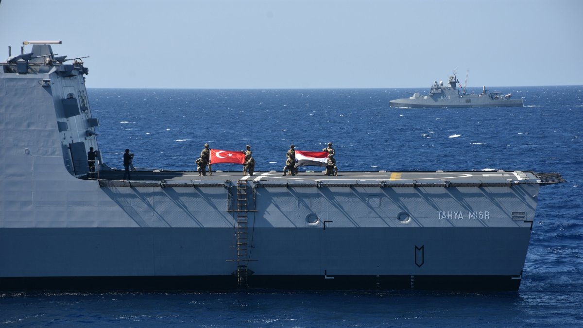 Turkish and Egyptian naval personnel display their national flags aboard a ship during the “Friendship Sea 2025” exercise, Muğla, Türkiye, Sept. 25, 2025. (AA Photo)
