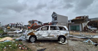 A damaged car is seen amid debris and other damaged buildings after Typhoon Bualoi swept through Thanh Hoa, Vietnam, Sept. 29, 2025. (AP Photo)