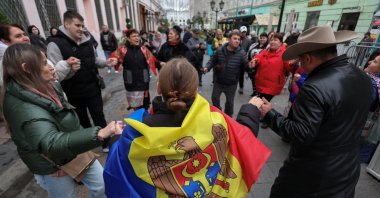 People dance in the street outside the Moldovan Embassy where Moldovan citizens vote in parliamentary elections, in Moscow, Russia, September 28, 2025. REUTERS/Ramil Sitdikov