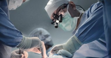 Doctors perform a cardiac stent procedure on a patient in a medical facility. (Shutterstock Photo)