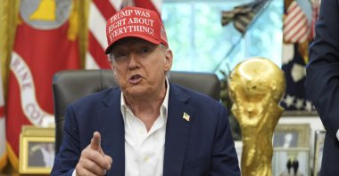 President Donald Trump speaks alongside the FIFA World Cup Winners Trophy in the Oval Office of the White House, Washington, U.S., Aug. 22, 2025. (AP Photo)