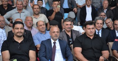 Turkish Wrestling Federation President Taha Akgül (L), Afşin Mayor Koray Kıraç (C), and national wrestler Rıza Kayaalp attend the 47th Afşin Eshab-ı Kehf Culture and Karakucak Wrestling Festival, Kahramanmaraş, Türkiye, Sept. 29, 2025. (AA Photo)