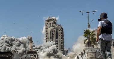 A journalist films an Israeli airstrike on the Mushtaha Tower in the west of Gaza City, Gaza Strip, Sept. 5, 2025. (EPA Photo)