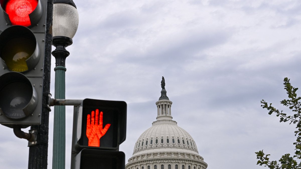 Traffic lights are seen in front of the US Capitol dome in Washington, DC, U.S., Sept. 30, 2025. (AFP Photo)