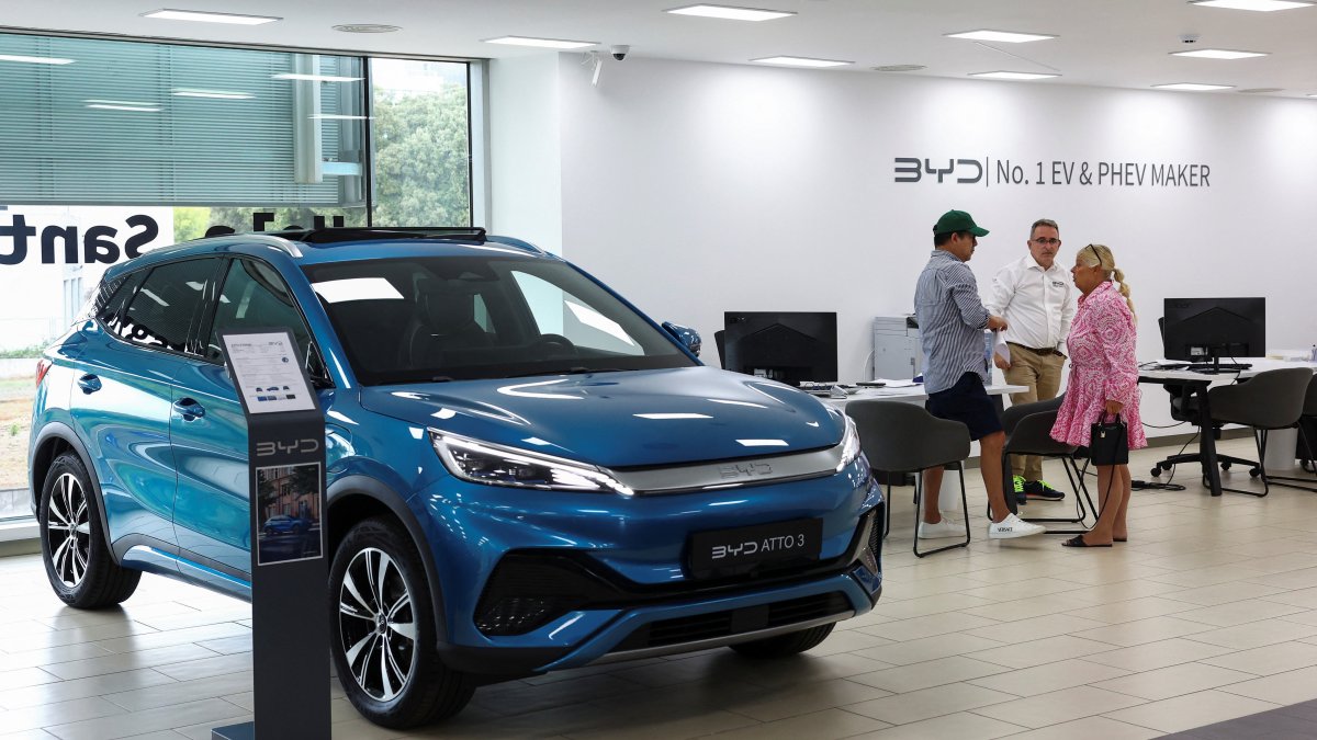 Customers speak with a salesman at a BYD dealership in Sant Cugat del Valles, near Barcelona, Spain, Sept. 12, 2025. (Reuters Photo)