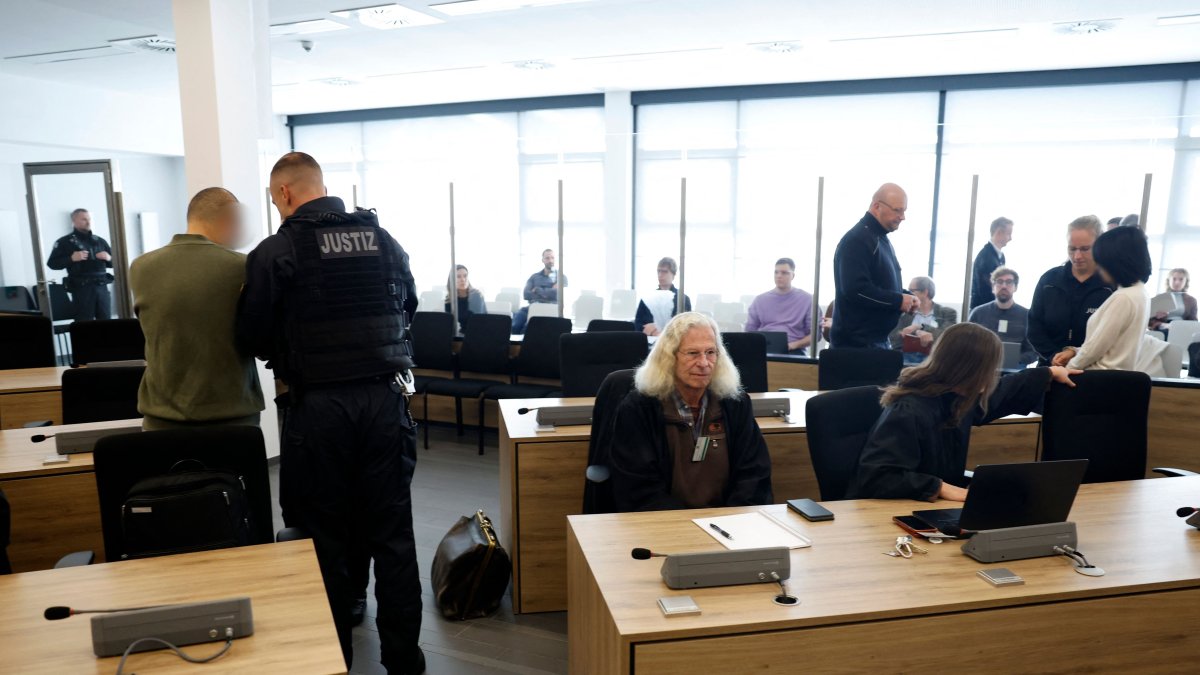 The two defendants (Jian G at L and Yaqi X at R) are being uncuffed as they arrive at a room of the higher regional court in Dresden, eastern Germany, Sept. 30, 2025. (AFP Photo)