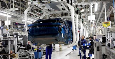 Employees are at work on the production line of the new Peugeot e-3008 and e-5008 electric car at the Stellantis factory, Sochaux, France, Oct. 3, 2024. (AFP Photo)