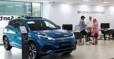 Customers speak with a salesman at a BYD dealership in Sant Cugat del Valles, near Barcelona, Spain, Sept. 12, 2025. (Reuters Photo)