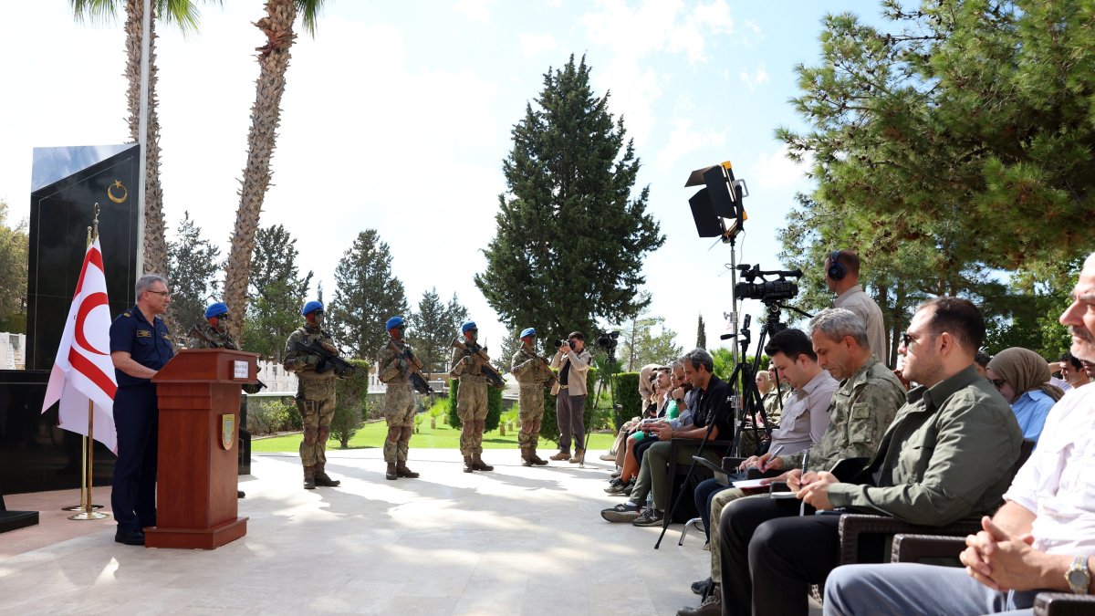 Flanked by troops, Defense Ministry spokesperson Zeki Aktürk speaks at a news conference, Girne (Kyrenia), TRNC, Oct. 2, 2025. (AA Photo)
