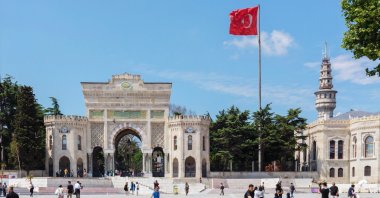 The main entrance gate of Istanbul University in Beyazıt Square with Beyazıt Tower in the background, Istanbul, Türkiye. (Shutterstock Photo)