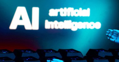 A message reading &quot;AI artificial intelligence,&quot; a keyboard and robot hands are seen in this illustration taken Jan. 27, 2025. (Reuters Photo)