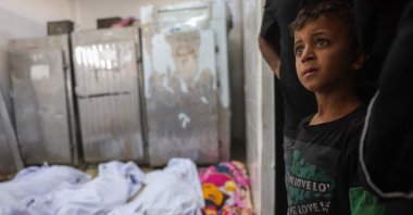 A Palestinian boy stands near bodies of casualties of Israeli strikes in Deir al-Balah, at the mortuary of Al-Aqsa Martyrs Hospital, Gaza Strip, Palestine, Oct. 2, 2025. (AFP Photo)