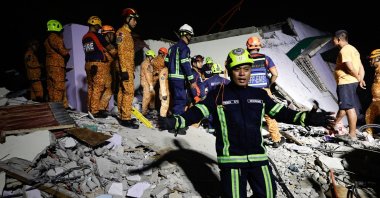 Philippine emergency response personnel try to clear a path during a retrieval operation at the site of an earthquake-damaged, collapsed facility, Bogo City, Cebu, Philippines, Oct. 1, 2025. (EPA Photo)