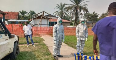 Men stand outside an Ebola treatment center in the remote Bulape Health Zone, Kasai province, DRC, Sept 7, 2025. (AP Photo)