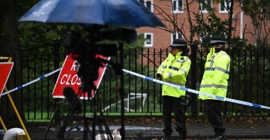 Police officers stand beside equipment from members of the media at the police cordon outside Heaton Park Hebrew Congregation synagogue in Crumpsall, north Manchester, Britain, Oct. 4, 2025. (AFP Photo)