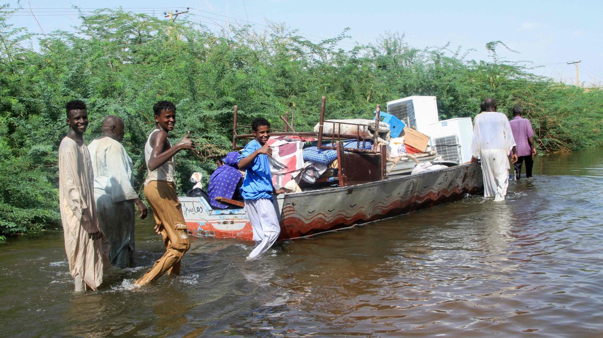 Residents use a barge to salvage belongings due to the flooding of the Nile river in the village of Wad Ramli north of Khartoum, Sudan, Oct. 1, 2025. (AFP Photo)