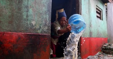 A woman pumps water from her flooded house in Kathmandu, Nepal, Oct. 5, 2025. (DHA Photo)