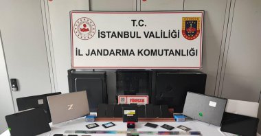 Seized digital materials, cryptocurrency wallets, and cash are displayed during the cybercrime operation in Istanbul, Türkiye, Oct. 5, 2025. (IHA Photo)