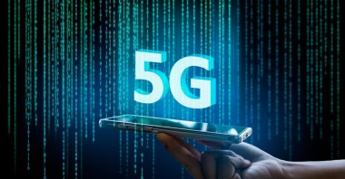 A 5G network digital hologram is seen over a mobile phone in this undated illustration. (Shutterstock Photo)