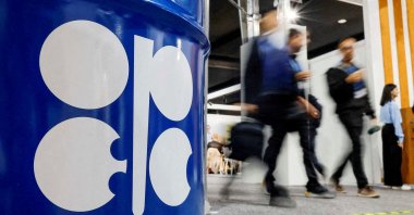 People walk past an installation depicting a barrel of oil with the OPEC logo during the COP29 United Nations climate change conference, Baku, Azerbaijan, Nov. 19, 2024. (Reuters Photo)