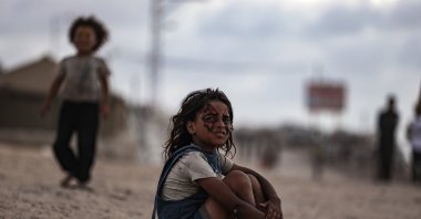 A Palestinian child sits on a beach in the Nuseyrat area amid Israeli attacks on the Gaza Strip, Oct. 5, 2025. (AA Photo)