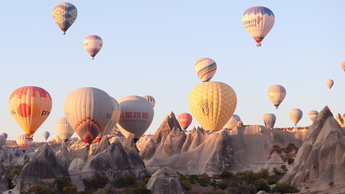 Hot air balloons fill the sky over Cappadocia as Chinese tourists explore the region during Golden Week, Cappadocia, Nevşehir, Türkiye, Oct. 2, 2025. (AA Photo)