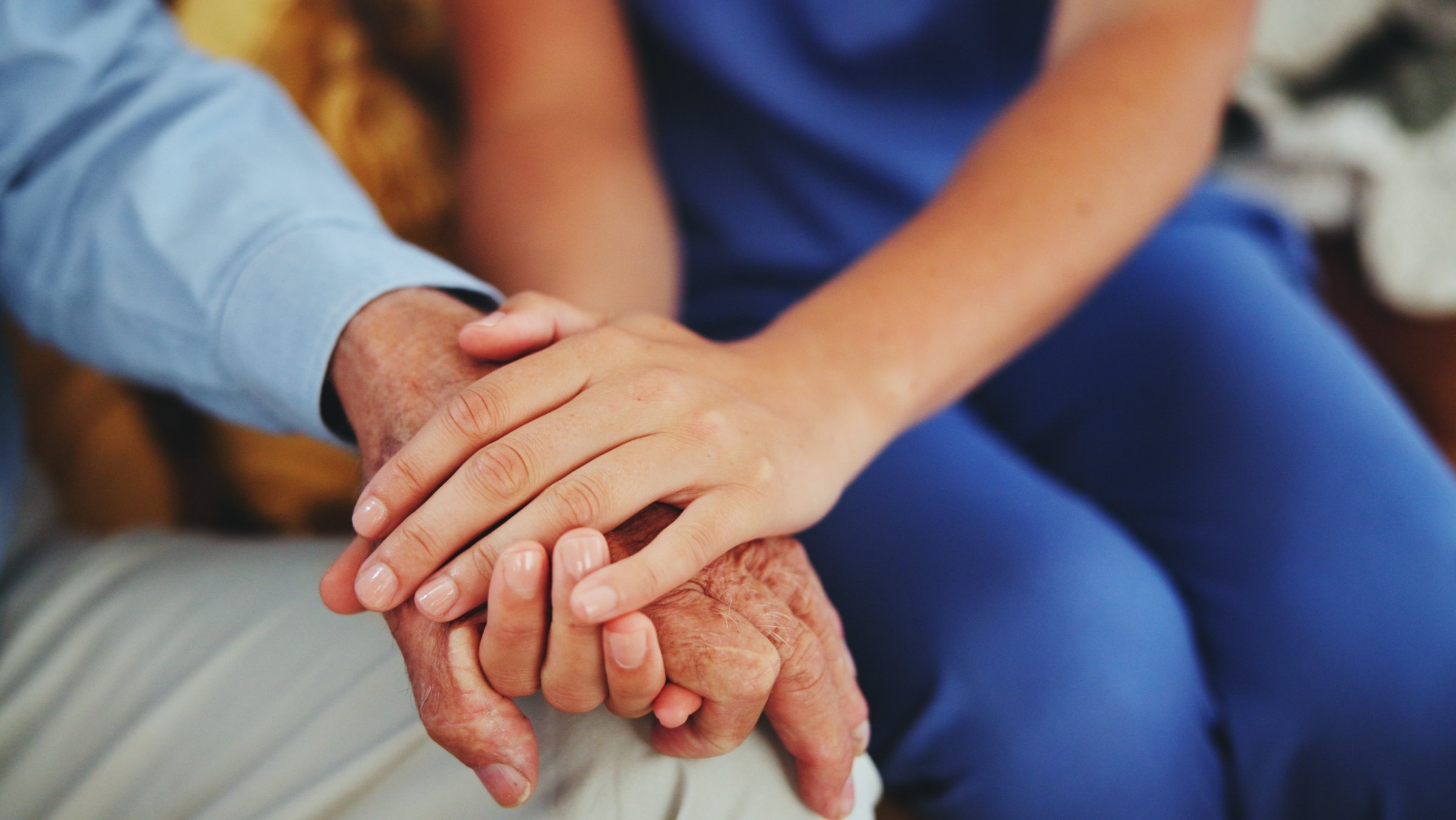 A nurse provides personal care to an elderly citizen at home. (Shutterstock Photo)