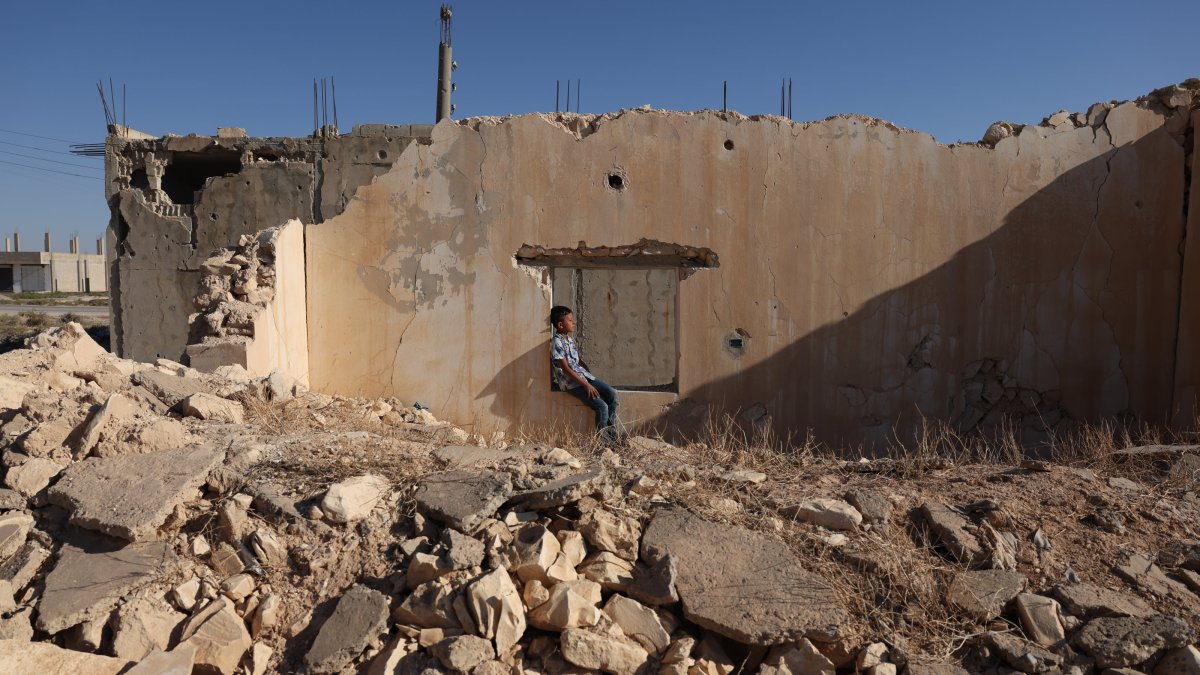 A child is seen in the Manbij district of Aleppo province, Syria, Sept. 11, 2025. (AA Photo)